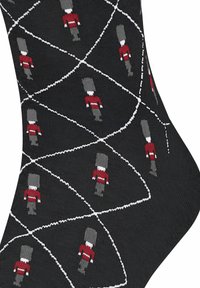 Calze nere con un motivo a diamante che presenta figure di soldati grigie e rosse, dettagliate con linee bianche che formano forme geometriche.