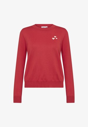Rdeč pulover z dolgimi rokavi, okroglo izrezom in rebrastim robom. Na levi strani prsnega dela so tri majhne bele srčke.