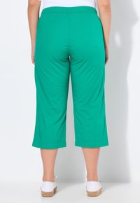 Grüne, leichte Baumwollmischung-Culottes mit einem elastischen Bund, cropped Länge und einer glatten Textur, die ein einfaches Design aufweisen.