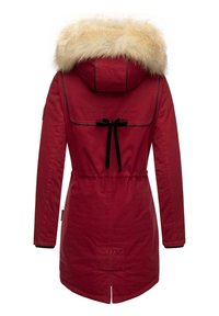 Red parka with a faux fur hood, drawstring waist, and black accents. Features a back vent and logo patch at the hem. Smooth fabric texture.