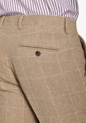 Beige Wollhosen mit einem subtilen Karomuster, Gesäßtasche mit einem dunklen Knopf und einer glatten Textur. Taillierte Passform.