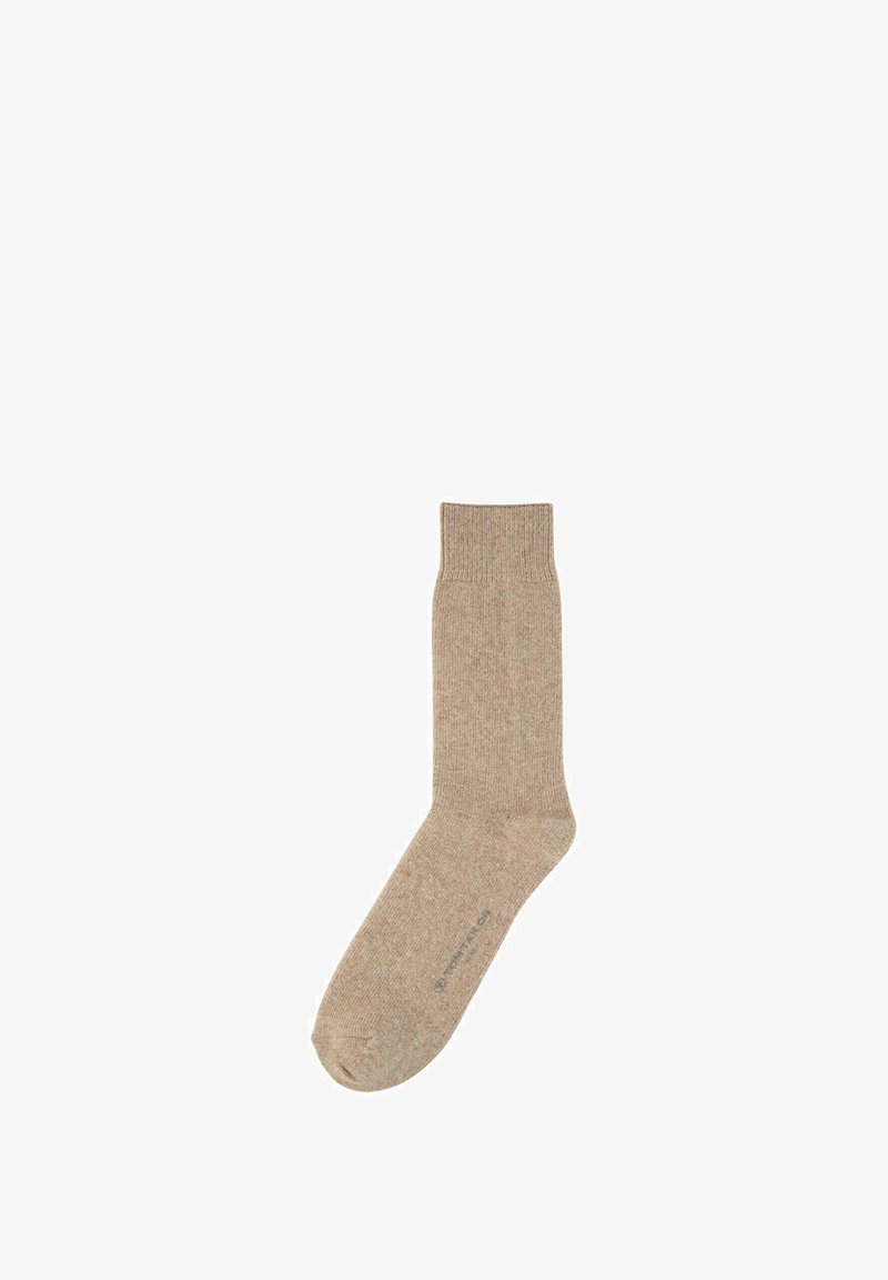 Calcetín de algodón beige con un puño acanalado, textura suave y puntera reforzada. Presenta una marca mínima en la suela.