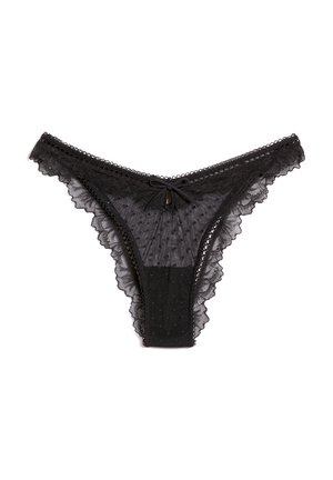 Tanga negra con ribete de encaje, tejido de malla con lunares, detalle de lazo central y bordes con forma de ondas, diseñada para una apariencia delicada.