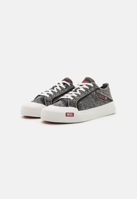 Gray denim sneakers with white rubber soles, featuring red accents, white laces, and stitched detailing along the sides.
