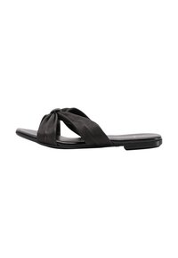 Sandali neri piatti con un design di cinturino attorcigliato, realizzati in materiale texturizzato, caratterizzati da una forma elegante e minimalista e una suola liscia.