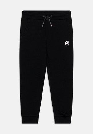 Pantalones de chándal negros hechos de una mezcla de algodón, con cinturilla elástica con cordón, bolsillos laterales y un pequeño logo circular en el muslo izquierdo.