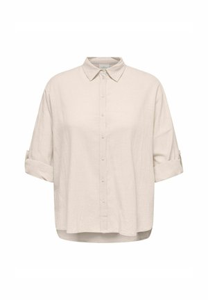 Chemise en lin beige clair avec une fermeture à boutons sur le devant, des manches courtes retroussées et une coupe décontractée. Texture douce avec un motif tissé subtil.