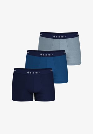 Trois paires de boxers pour hommes en marine, bleu et gris clair avec des ceintures foncées portant l'inscription "Eminence".