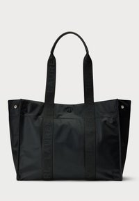 Black nylon tote bag with flat handles, featuring embossed logo, metallic accents, and a simple, structured design.