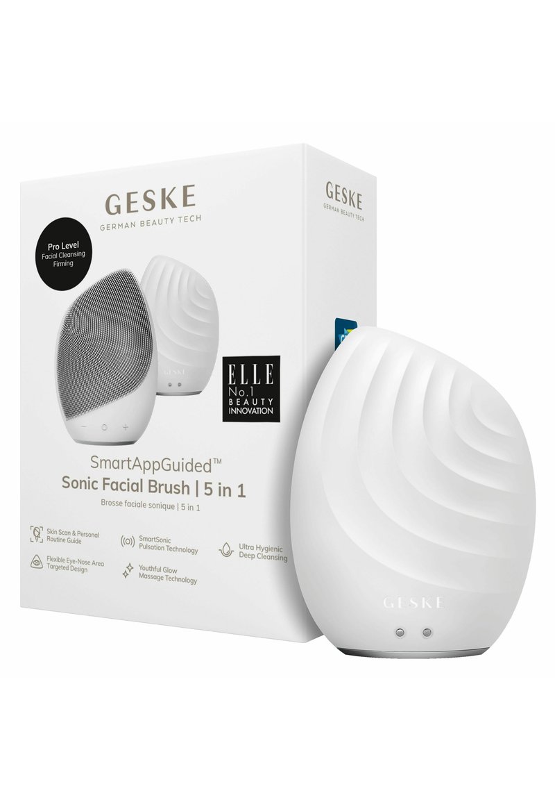 Sonic ansigtsbørste i hvid silikone med bølgemønster, ledsaget af en mærkeæske. Funktioner inkluderer knapper og et slankt, ergonomisk design.