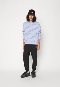 Jordan Pantaloni de trening - black/white