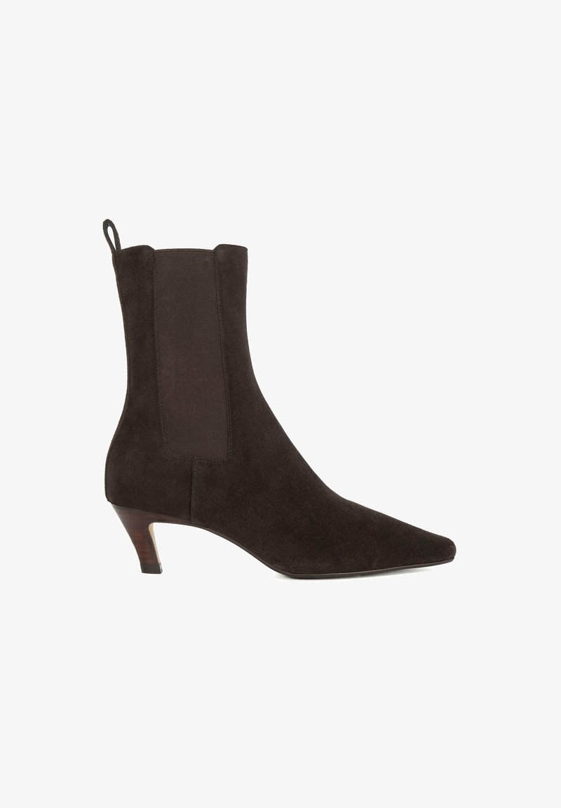 Black suede ankle boot with a pointed toe and small heel. Features elastic side panels for easy wear. Smooth texture with a minimalist design.