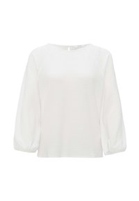 Haut à manches longues blanc en tissu texturé, avec un col rond et des manches raglan, présentant un détail en forme de trou de serrure dans le dos.