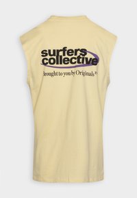 Sleeveless beige shirt with black and purple text reading "surfers collective Brought to you by Originals" on the back.