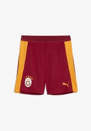 Bordeauxrote Sportshorts mit gelben Seitenpaneelen, vorne mit Galatasaray-Logo und Puma-Logo.