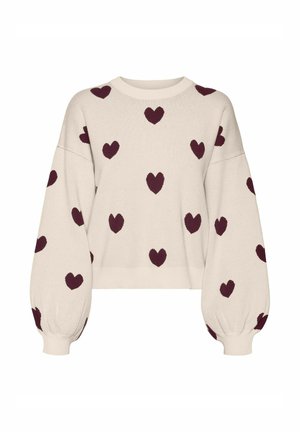 Pull crème avec manches ballon et poignets côtelés, arborant un motif répété de cœurs bordeaux tout au long. Design court.