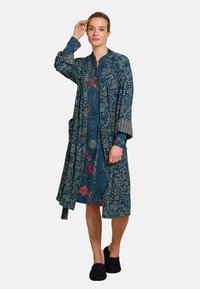 Kimono-style robe in dark blue fabric with floral patterns, long sleeves, and a tie belt. Features striped accents on the cuffs.