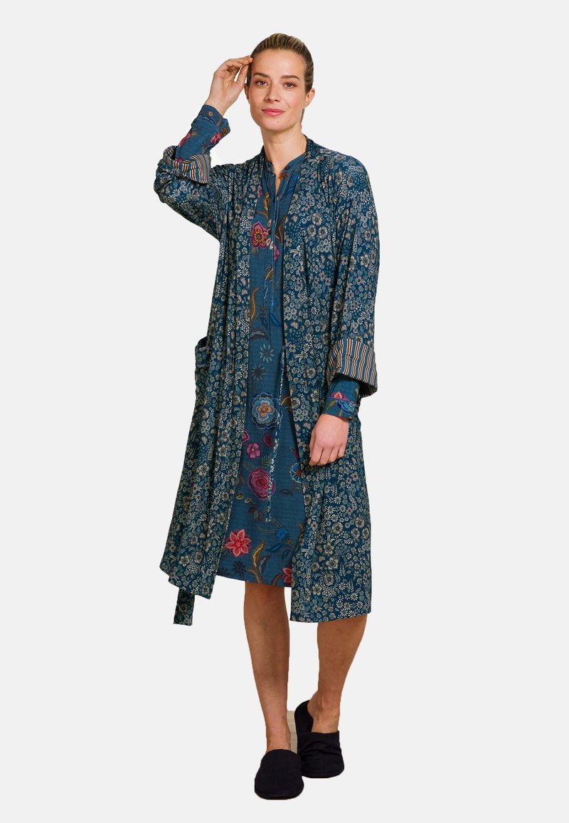 Kimono-style robe in dark blue fabric with floral patterns, long sleeves, and a tie belt. Features striped accents on the cuffs.