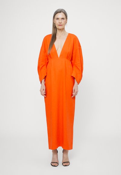 Long orange dress with a deep V-neck, wide sleeves, and a loose fit. Made of lightweight fabric, featuring a smooth texture and minimal details.