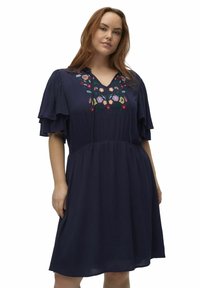 Vestido azul marino, hasta la rodilla, con mangas cortas con volantes y escote en V. Decorado con colorido bordado floral a lo largo del escote.