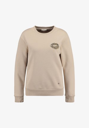 Beżowy sweatshirt z okrągłym dekoltem, ściągaczami przy mankietach oraz wzorem w panterkę na linii klatki piersiowej. Miękka tkanina, luźny krój.