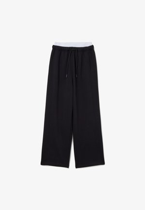 Schwarze weit geschnittene Sweatpants mit elastischem Bund, Kordelzug, Seitennähten und weichem Stoff. Geeignet für legere Kleidung.