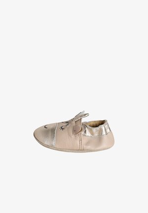 Soft beige baby shoe with metallic toe and heel, decorated with closed eyes, ears, and a small flower on top.