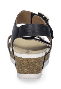 Czarne skórzane sandały z korkową wkładką, białą podeszwą i regulowanym paskiem z złotym zapięciem, prezentujące teksturowany wzór.
