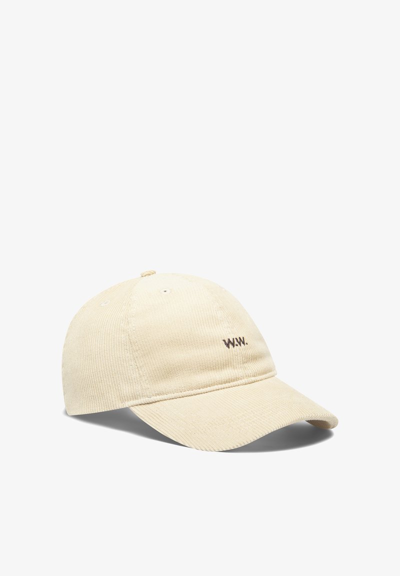 Beige corduroy baseball cap featuring a stitched "W.W." logo. Includes a curved brim and ventilation holes, presenting a textured surface.