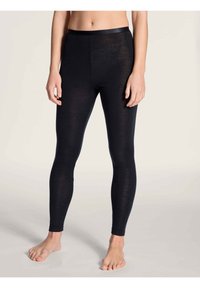 Leggings neri realizzati in un materiale morbido ed elastico, caratterizzati da una vita liscia e un design aderente, adatti per diverse attività.