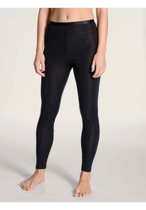 Leggings noirs en matériau doux et extensible, avec une taille lisse et un design ajusté, adaptés à diverses activités.
