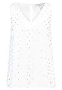 Vit ärmlös blus med V-ringning, prydd med silverfärgade prickar och en nyckelhålsöppning bak. Tillverkad av lättviktsmaterial.