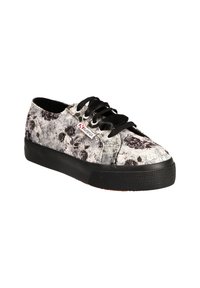 Black lace-up sneaker with a grey floral pattern on soft fabric, featuring a thick black rubber sole and a small brand logo tag.