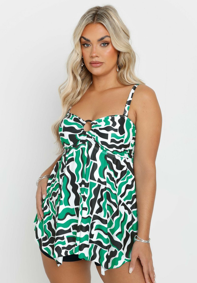 Uimapuku, jossa on mustavalko-vihreä kuosi, avotaskuyksityiskohta, leveät olkaimet ja liehukkapohja mukavuuden lisäämiseksi.