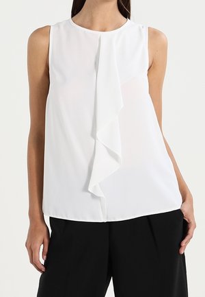 Witte mouwloze blouse met een drapédetail aan de voorkant, gemaakt van gladde stof. Heeft een ronde halslijn en een ontspannen pasvorm, gecombineerd met zwarte broek.