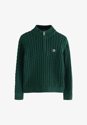 Žalias megztinis su pynimo raštu ir pusiau užtraukiamu apykakliuku, su ribotomis rankogalėmis ir apačia, bei mažu siuvinėtu logotipu kairėje krūtinės pusėje.