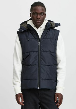 Navy puffer vest with a hood, zip closure, and side pockets. Features stitched panels and an adjustable drawstring at the hood.