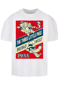Hvit bomulls t-skjorte med et vintage tegneserieprint av tre griser og en ulv, med røde og blå tekst og utlinjede illustrasjoner.