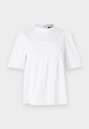 Valkoinen lyhythihainen paita, jossa korkea kaulus, pystysuuntaiset laskokset rinnan kohdalla ja hieman levenevä helma.