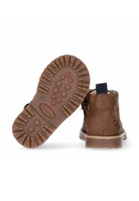 Bruine leren enkelboots met een gestructureerde rubberen zool met sterpatronen, een ritssluiting aan de zijkant en een treklabel voor gemakkelijk aan- en uittrekken.