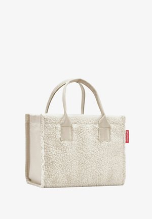 White shearling tote bag with beige fabric accents, two short handles, and a red logo tag on the side. Rectangular shape, soft texture.