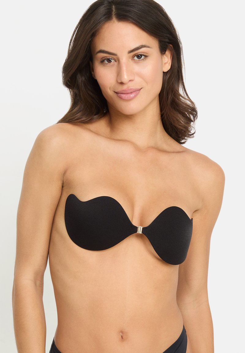 Black strapless adhesive bra with a smooth texture, contoured shape, and gold hardware in the center, designed for a seamless fit.