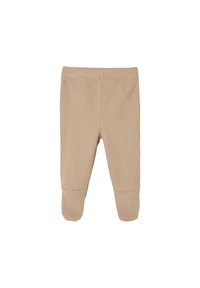 Beige Rippleggings mit eng anliegendem Schnitt, ausgestattet mit einem weichen Bund und genähten Akzenten nahe dem Knöchel. Der Stoff wirkt glatt und dehnbar.