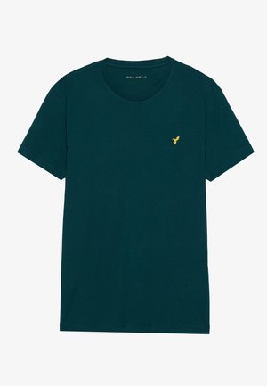 Grøn bomulds t-shirt med korte ærmer og rund hals. Har et lille guld-fuglelogo på venstre bryst. Enkel design, ensfarvet.