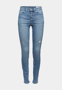 Jeans de mezclilla azul de corte skinny, de tiro alto, con cierre de cinco botones, ligero desgaste y detalles desgastados cerca de las rodillas. Textura suave.