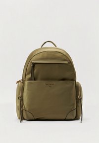 Olive green nylon backpack with a front zip pocket, gold hardware accents, and adjustable straps. Smooth texture and rounded shape.