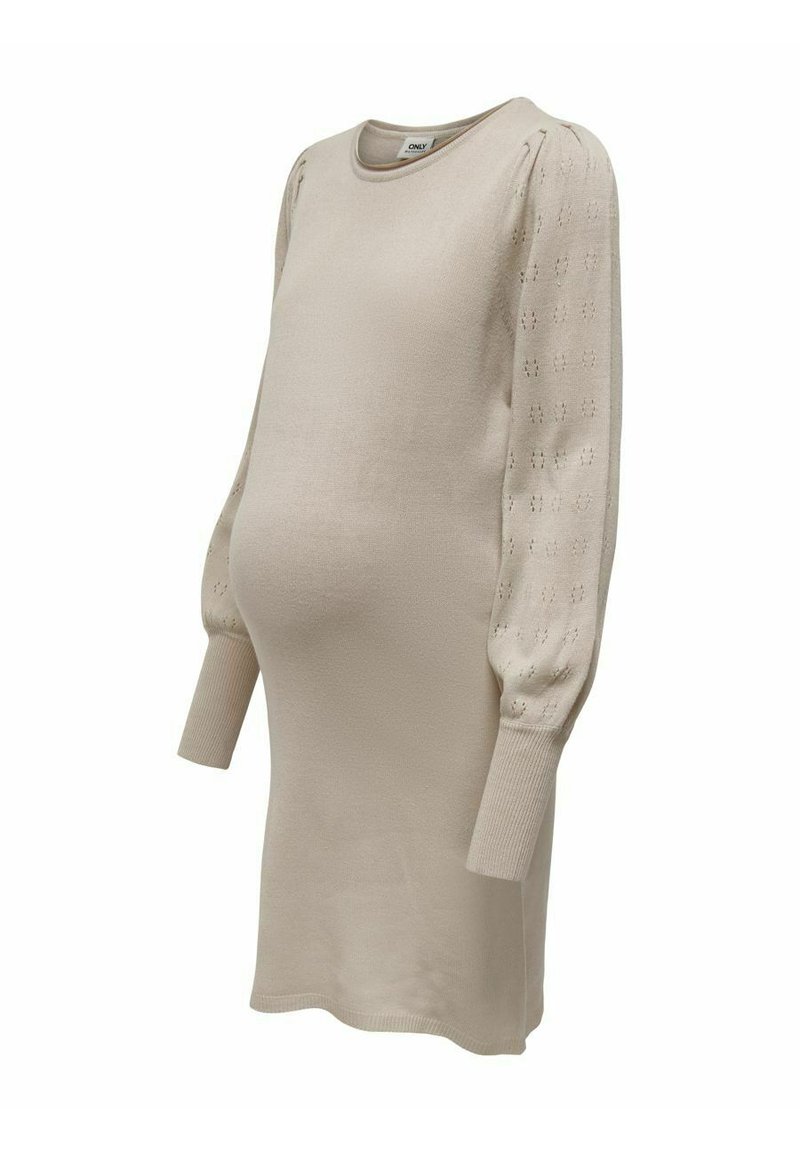 Ljusbeige stickad gravidklänning med långa ärmar, med texturerade puffärmar och ribbade muddar, designad för komfort och stil.