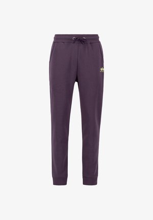 Pantaloni della tuta viola realizzati in materiale morbido, con vita elasticizzata e cordoncino, polsini a coste e tasche laterali. Accento del logo giallo.