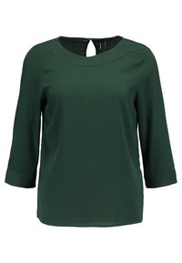 Blouse vert foncé à manches trois-quarts, encolure ronde, détails cousus sur les épaules et les poignets, et petite fermeture à bouton dans le dos.