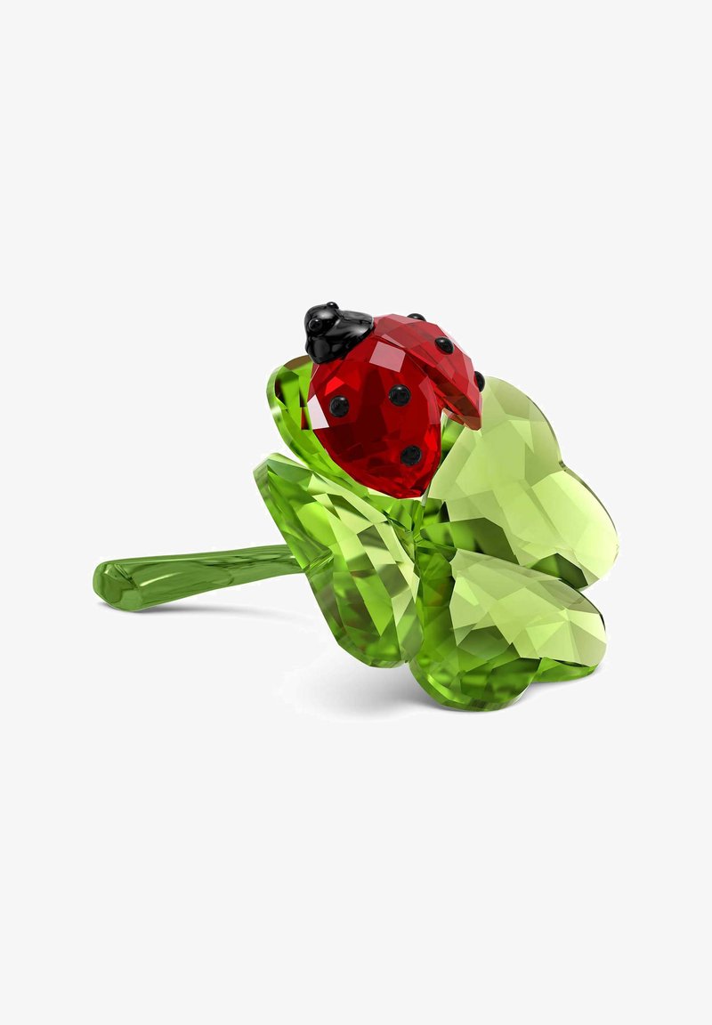 Fiore di cristallo verde con un accento di coccinella rossa. Presenta una texture sfaccettata e un gambo liscio ed allungato. La coccinella ha macchie nere e testa.